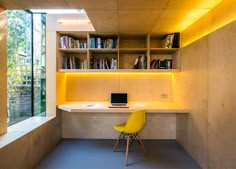 a yellow chair sitting in front of a desk