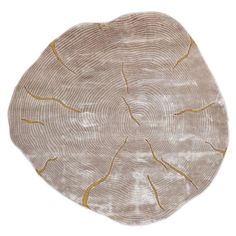 a beige rug with gold lines on it and a circular design in the middle, against a white background