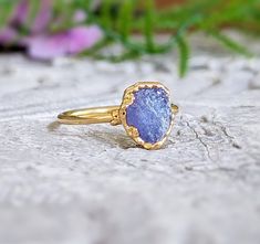 Rustic but elegant, our December birthstone ring features a stunning Raw Tanzanite uniquely handcrafted on a 14k gold-filled band. This lovely purple crystal ring will make a great gift on special occasions such as Birthdays, Mother's Day, and Christmas, and a unique engagement ring on Valentine's Day.T H E ∙ S M A L L ∙ D E T A I L S• One 7-9mm raw Tanzanite• 14k Gold filled bandM A T E R I A L ∙ O P T I O N S• Silver: set on a Sterling Silver band, the bezel is electroformed and plated in Fine Raw Tanzanite Ring, Raw Tanzanite, Tanzanite Studs, December Birthstone Ring, Raw Crystal Ring, Tanzanite Jewelry, Raw Stone Ring, Gold Promise Rings, Unique Engagement Ring