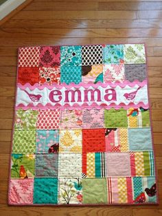 a colorful quilt with the word emma on it's front and bottom corner