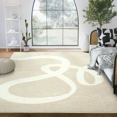 a living room with a large window and white rug