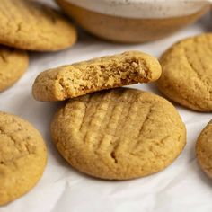 several peanut butter cookies are stacked on top of each other, with one cookie in the middle