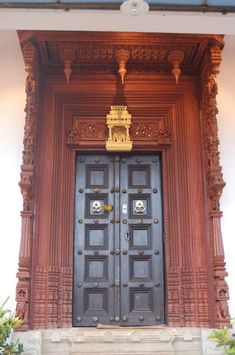 an ornate wooden door in front of a building