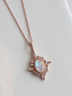 The Aurora Necklace features a luminous moonstone center surrounded by sparkling cubic zirconia, set in rose gold-plated sterling silver. With its 18-inch chain, this elegant piece captures the beauty of the night sky and adds a touch of celestial charm to any outfit. Celestial Rose Gold Jewelry With Rose Cut Diamonds, Celestial Rose Gold Cubic Zirconia Jewelry, Elegant Rose Gold Moonstone Jewelry, Aurora Necklace, The Aurora, The Night Sky, Gold Plated Sterling Silver, Night Sky, Rose Gold Plates