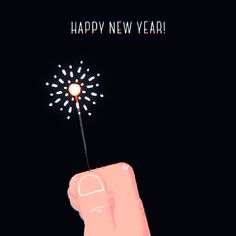 a hand holding a sparkler with the words happy new year written on it's side