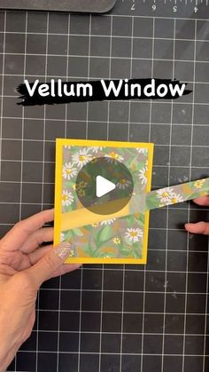 someone cutting up a card with scissors on top of the board that says,'vellum window '