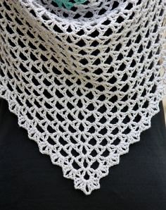 a woman wearing a white crochet shawl