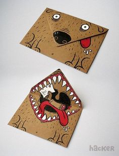 two envelopes that have been made to look like animals with mouths and teeth on them