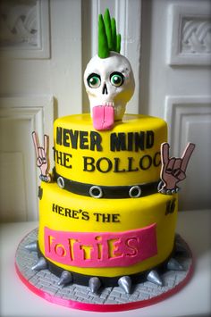 a yellow cake with a skull on top that says never mind the bolloo here's the lonies