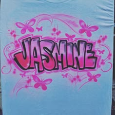 a blue t - shirt with the word jashine painted on it