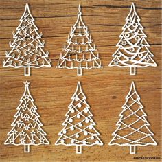 christmas trees cut out from paper on a wooden surface