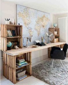 a desk made out of wooden pallets with a map on the wall