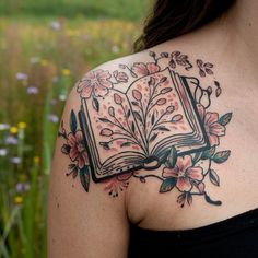 a woman with a book tattoo on her shoulder and chest is looking at the camera