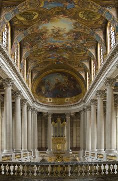 the interior of an ornate building with painted ceilings