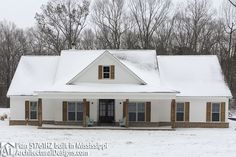 a white house covered in snow next to trees