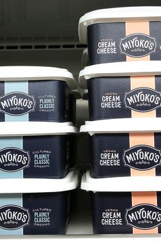 six ice cream containers stacked on top of each other in a store display case,