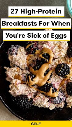 a black plate topped with breakfast foods on top of a table