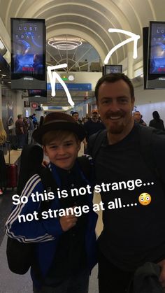 a man standing next to a little boy in an airport terminal with the caption saying so this is not strange, not strange at all