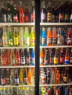 two refrigerators filled with lots of different kinds of drinks