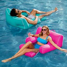 two people floating on inflatable rafts in a swimming pool, one woman wearing sunglasses and the other holding a water bottle