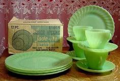 green plates and cups sitting on top of a table next to a box of tissues