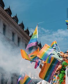 people in colorful costumes are flying kites