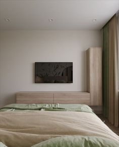 a bedroom with a large bed and a flat screen tv mounted on the wall