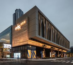 an empty street in front of a building with tall buildings on both sides and the word ikea written on it