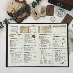 the contents of a planner spread out on a table with various stamps and other items