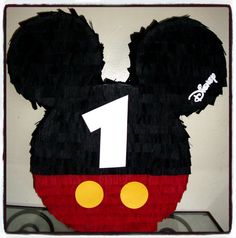 a mickey mouse birthday cake with the number one on it's face and ears