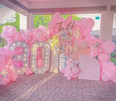 a room decorated with balloons and letters that spell out the word 100