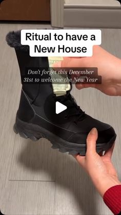 a person is holding a black shoe with the words ritual to have a new house