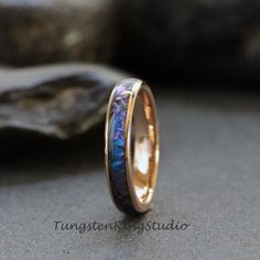 a gold ring with blue opal inlay