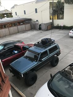 several cars parked in a parking lot next to each other