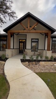 a house with a walkway leading to the front door