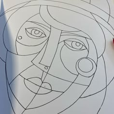 a drawing of a woman's face with circles and lines on the paper next to it