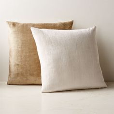 two pillows sitting next to each other on a table