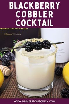 the blackberry cobbler cocktail is garnished with blackberries