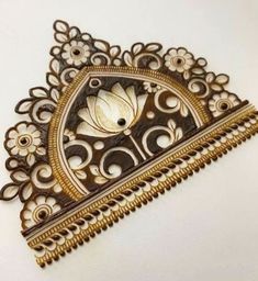 an intricately designed brooch is shown on a white surface