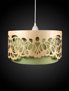 a wooden light fixture with an intricate design on the top and bottom, hanging from a cord