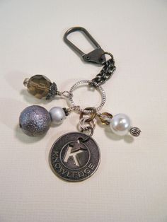 a close up of a keychain with charms on it's back end