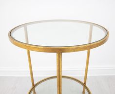 a round glass table with gold metal legs