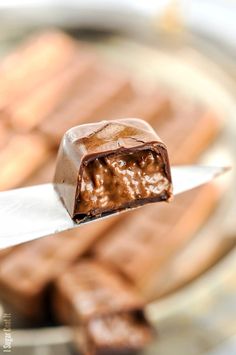 a piece of chocolate sitting on top of a knife