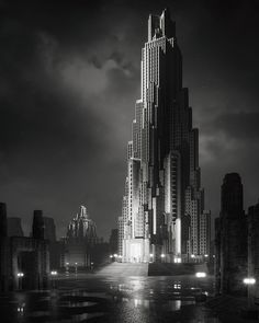 a black and white photo of a very tall building in the middle of a city