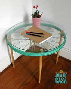 a glass table with a book on it and a plant in a pot next to it