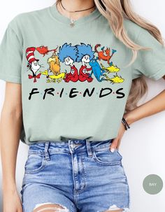 Join the whimsical world of Dr. Seuss with our Seuss Squad Friends Tee! Featuring beloved characters from the enchanting stories of Dr. Seuss, this shirt brings a splash of nostalgia and fun to your wardrobe. Made from soft, premium cotton, it offers all-day comfort and durability. Whether you're a lifelong fan or introducing these classic tales to a new generation, this tee is perfect for showing off your Seuss spirit. Ideal for casual outings, school, or cozy days at home, the Seuss Squad Friends Tee is a delightful addition to any Seuss lover's collection. Embrace the joy and magic of Dr. Seuss with this charming and colorful shirt! Themed Cartoon Print Crew Neck T-shirt, Fun Relaxed Fit Shirt With Character Print, Fun Cartoon Print Shirt With Relaxed Fit, Fun Relaxed Fit Shirt With Cartoon Print, Themed Long Sleeve Tops With Cartoon Print, Themed Long Sleeve Top With Cartoon Print, Cotton Crew Neck Shirt With Character Print, Relaxed Fit Crew Neck Shirt With Character Print, Pop Culture Crew Neck Top With Funny Print