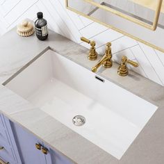 a bathroom sink sitting under a mirror next to a faucet