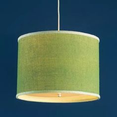 a green lampshade hanging from a ceiling with a blue sky in the background