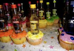 cupcakes and bottles of alcohol on a table