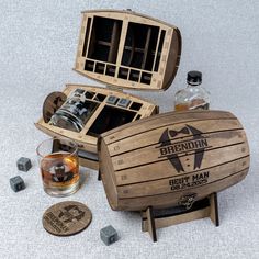 an open wooden box with two bottles and some dices